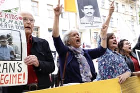 Supporters of the People's Mojahedin of Iran protest outside a Stockholm court on the first day of the trial of an Iranian man for war crimes over the execution of political prisoners in 1988 in Karaj, Iran (Picture: Stefan Jerrevang/TT NEWS AGENCY/AFP via Getty Images)