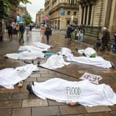 Whilst people lie on the ground covered in white sheets, a sombre drum beat will echo through the busy shopping area.