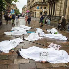 Whilst people lie on the ground covered in white sheets, a sombre drum beat will echo through the busy shopping area.