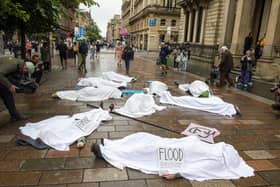 Whilst people lie on the ground covered in white sheets, a sombre drum beat will echo through the busy shopping area.