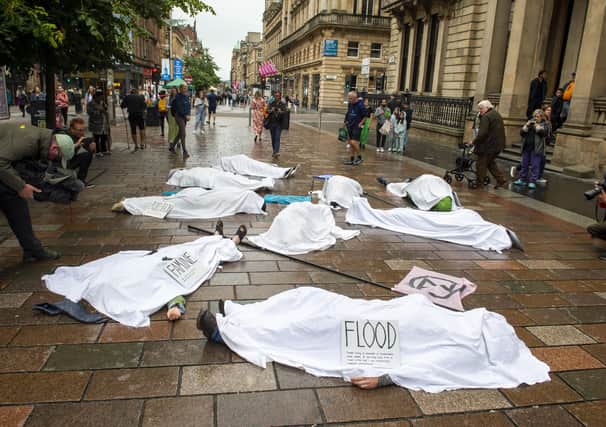 Whilst people lie on the ground covered in white sheets, a sombre drum beat will echo through the busy shopping area.
