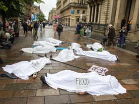 Whilst people lie on the ground covered in white sheets, a sombre drum beat will echo through the busy shopping area.