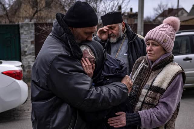 Relatives of a civilian man exhumed from his garden in Gostomel village, Kyiv region, on Tuesday comfort each other (Picture: Fadel Senna/AFP via Getty Images)