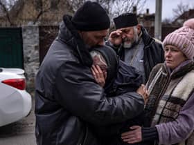 Relatives of a civilian man exhumed from his garden in Gostomel village, Kyiv region, on Tuesday comfort each other (Picture: Fadel Senna/AFP via Getty Images)