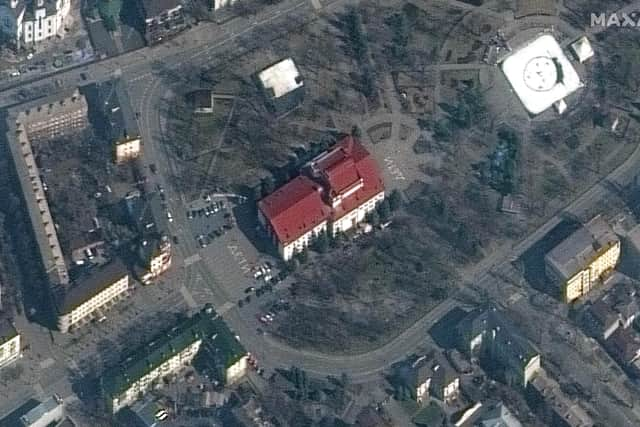 This satellite image provided by Maxar Technologies shows the Mariupol Drama Theater in Mariupol, Ukraine on Monday, March 14, 2022. Ukrainian officials say Russian forces destroyed the theatre in the city of Mariupol where hundreds of people were sheltering.The Maxar satellite imagery firm said images from Monday showed the word children had been written in large white letters in Russian in front of and behind the building. (Maxar Technologies via AP)