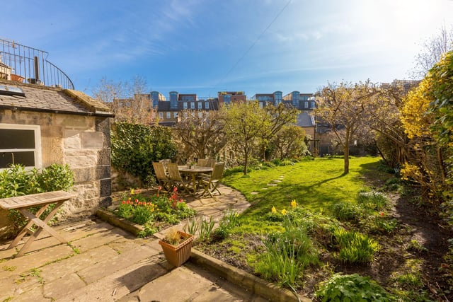 To the rear, there is a charming south-east facing walled garden with mature plantings and trees. It has a couple of seating areas to take full advantage of sun and shade, and a gate to a double garage.