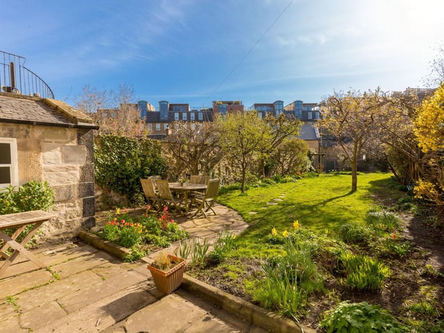 To the rear, there is a charming south-east facing walled garden with mature plantings and trees. It has a couple of seating areas to take full advantage of sun and shade, and a gate to a double garage.