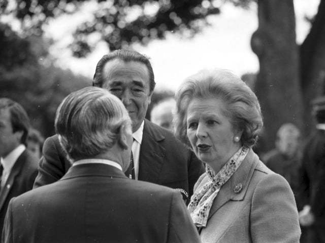 Prime Minister Margaret Thatcher speaks to Peter Heatly and Robert Maxwell when she visited the Games village during the Edinburgh Commonwealth Games.