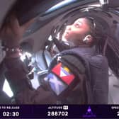 Anastatia Mayers (front L), 18, Jon Goodwin (back R), 80, and Chief Astronaut Instructor Beth Moses (front R) looking out of windows while in Space (Photo by Virgin Galactic / AFP)