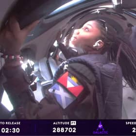Anastatia Mayers (front L), 18, Jon Goodwin (back R), 80, and Chief Astronaut Instructor Beth Moses (front R) looking out of windows while in Space (Photo by Virgin Galactic / AFP)
