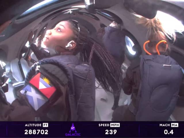 Anastatia Mayers (front L), 18, Jon Goodwin (back R), 80, and Chief Astronaut Instructor Beth Moses (front R) looking out of windows while in Space (Photo by Virgin Galactic / AFP)