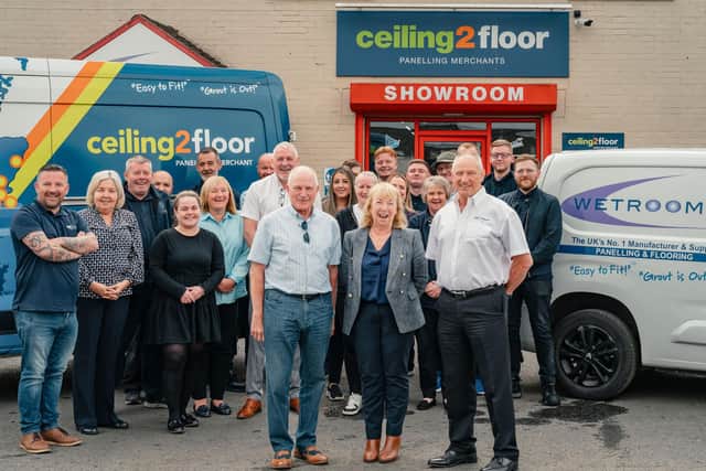Brian Crombie, front left, and Bill Crombie, front right, with Wetrooms International Group Managing Director Linda Smith, centre, and colleagues celebrating their employee ownership news
