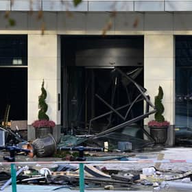 Debris are seen in front of the Radisson Blu hotel, where a huge aquarium located in the hotel's lobby burst this morning.