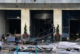 Debris are seen in front of the Radisson Blu hotel, where a huge aquarium located in the hotel's lobby burst this morning.