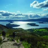 Green direction: hikers walk a trail above Loch Lomond, but the majority of tourism in Scotland still depends on fossil-fuelled transport.