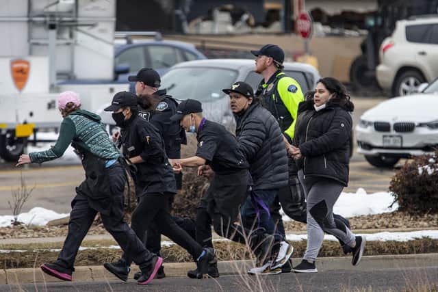 Shoppers are evacuated from a King Soopers grocery store after a gunman opened fire on March 22, 2021 in Boulder, Colorado (Photo by Chet Strange/Getty Images).