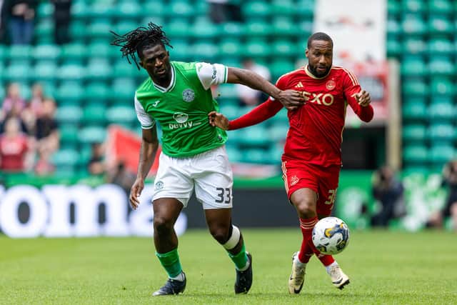 Hibs defender Rocky Bushiri tries to fend off the attentions of Junior Hoilett during the 4-0 defeat by Aberdeen.