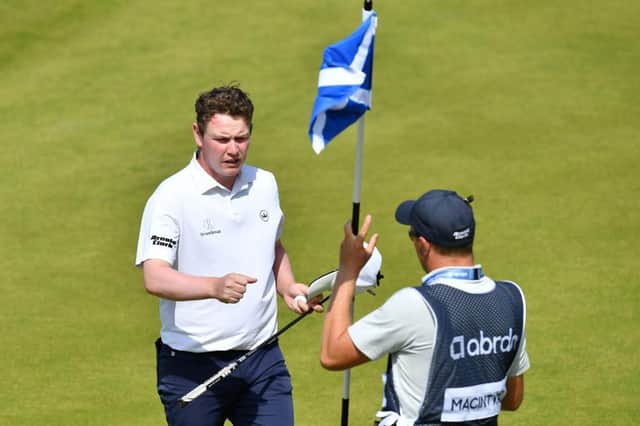Bob MacIntyre fist bumps caddie Mike Thomson at the end of the third round in the abrdn Scottish Open at The Renaissance Club. Picture: Mark Runnacles/Getty Images.