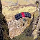 A base jumper is pictured from the ridge of Aonach Eagach, Glen Coe (Picture via SWNS)
