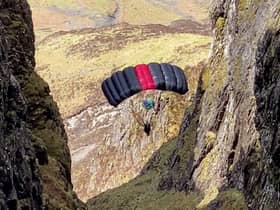 A base jumper is pictured from the ridge of Aonach Eagach, Glen Coe (Picture via SWNS)