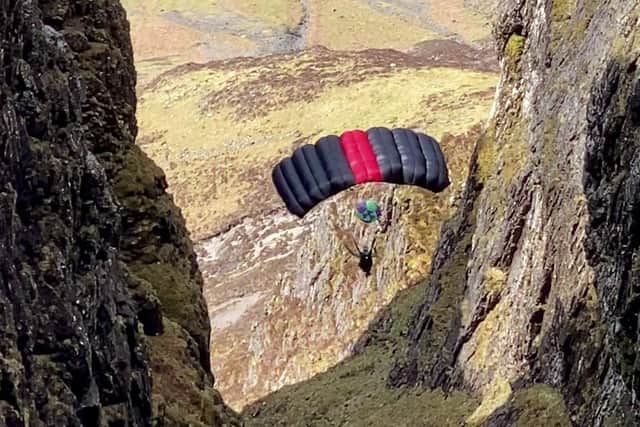 A base jumper is pictured from the ridge of Aonach Eagach, Glen Coe (Picture via SWNS)