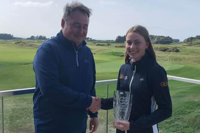 Royal Troon's Freya Russell is presented with the Stephen Gallacher Foundation Masters girls' trophy by Chris King, the GB&I chairman of selectors for the Jacques Leglise Trophy. Picture: SGF