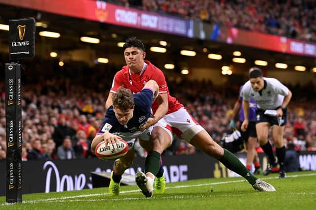 Darcy Graham scores Scotland's first-half try as he breaks through the tackle of Wales' Louis Rees-Zammit. (Photo by Stu Forster/Getty Images)