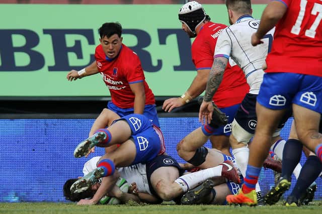 Damian Hoyland, partially hidden, forces his way over for his third try in the win over Chile in Santiago. (Photo by Marcelo Hernandez/Getty Images)
