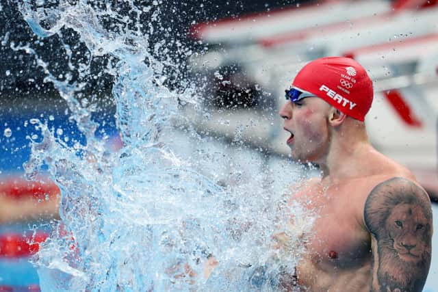 Adam Peaty celebrates winning gold in the Men's 100m Breaststroke Final on day three of the Tokyo 2020 Olympic Games at the Tokyo Aquatics Centre