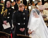 Prince William (left) watching Prince Harry and Meghan Markle during their wedding at St George's Chapel at Windsor Castle. Picture: Jonathan Brady/PA Wire