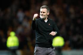 Motherwell manager Graham Alexander celebrates guiding his team into Europe.