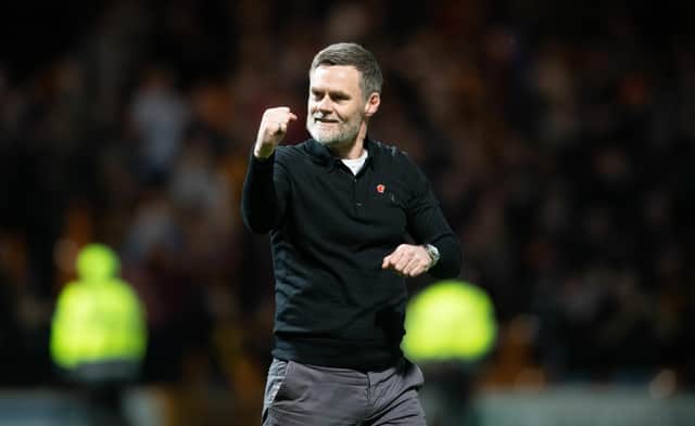 Motherwell manager Graham Alexander celebrates guiding his team into Europe.