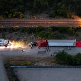 SAN ANTONIO, TX - JUNE 27: In this aerial view, members of law enforcement investigate a tractor trailer on June 27, 2022 in San Antonio, Texas. According to reports, at least 46 people, who are believed migrant workers from Mexico, were found dead in an abandoned tractor trailer. Over a dozen victims were found alive, suffering from heat stroke and taken to local hospitals. (Photo by Jordan Vonderhaar/Getty Images)