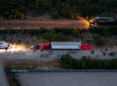 SAN ANTONIO, TX - JUNE 27: In this aerial view, members of law enforcement investigate a tractor trailer on June 27, 2022 in San Antonio, Texas. According to reports, at least 46 people, who are believed migrant workers from Mexico, were found dead in an abandoned tractor trailer. Over a dozen victims were found alive, suffering from heat stroke and taken to local hospitals. (Photo by Jordan Vonderhaar/Getty Images)