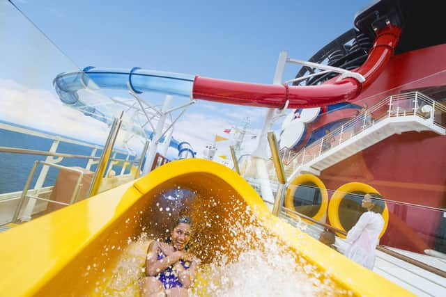 A guest on the AquaDunk waterslide on the Disney Magic.