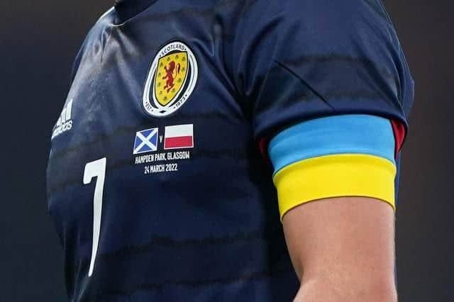 Scotland's John McGinn wears an armband with the Ukrainian colours during the international friendly against Poland in March (Picture: Andrew Milligan/PA)
