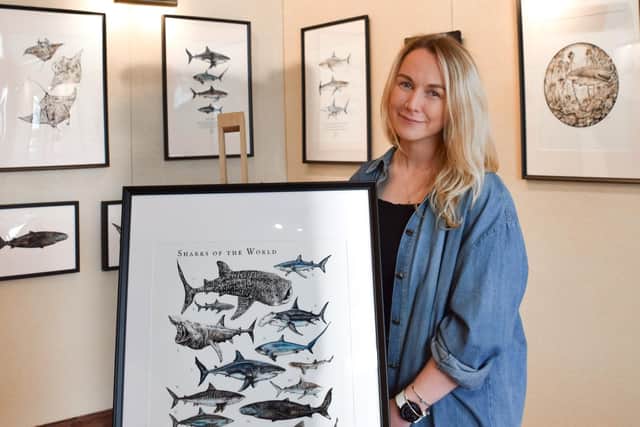 Wildlife artist and scientific illustrator Rachel Brooks holds up her contribution to an exhibition run by Samsung