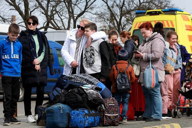 Refugees wait to load up on a bus that will take them to Poland from Lviv, Ukraine.