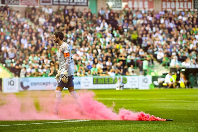 A pyrotechnic thrown from the Hearts end landed dangerously close to goalkeeper Craig Gordon.  (Photo by Rob Casey / SNS Group)