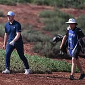 Connor Syme walks with his caddie, Ryan McGuigan, on the Earth Course at Jumeirah Golf Estates during the DP World Tour Championship. Picture: Ross Kinnaird/Getty Images.