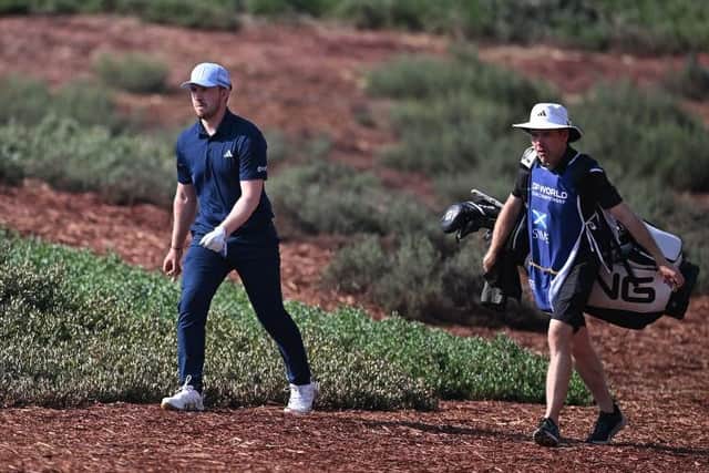 Connor Syme walks with his caddie, Ryan McGuigan, on the Earth Course at Jumeirah Golf Estates during the DP World Tour Championship. Picture: Ross Kinnaird/Getty Images.
