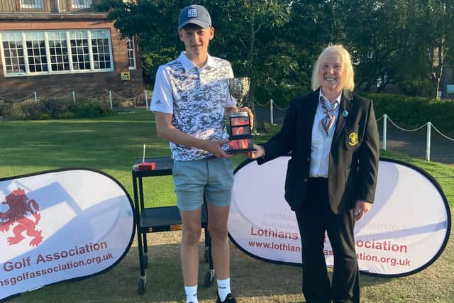 Fergus Brown after receiving the trophy from Lothians president Jean Macnab at the Braids. Picture: Lothians Golf Association.