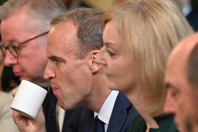 Justice Secretary Dominic Raab, with mug, and Liz Truss, who replaced him as Foreign Secretary, take part in a Cabinet meeting on Friday after the reshuffle (Picture: Ben Stansall/WPA pool/Getty Images)