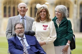 English broadcaster and journalist Kate Garraway stands with her husband Derek Draper and her parents Gordon and Marilyn Garraway, as she poses with their medal after being appointed a Member of the Order of the British Empire (MBE). Picture: Andrew Matthews/AFP via Getty Images