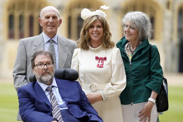 English broadcaster and journalist Kate Garraway stands with her husband Derek Draper and her parents Gordon and Marilyn Garraway, as she poses with their medal after being appointed a Member of the Order of the British Empire (MBE). Picture: Andrew Matthews/AFP via Getty Images