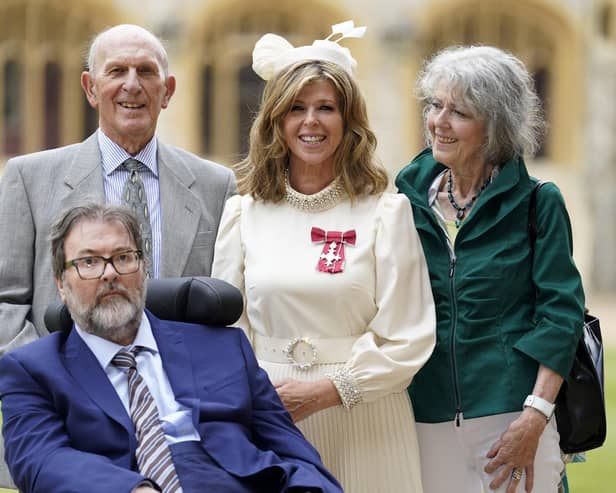 English broadcaster and journalist Kate Garraway stands with her husband Derek Draper and her parents Gordon and Marilyn Garraway, as she poses with their medal after being appointed a Member of the Order of the British Empire (MBE). Picture: Andrew Matthews/AFP via Getty Images
