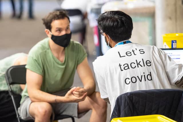 A man receives a Covid vaccine at Twickenham rugby stadium in London, where the vaccine was offered to local residents over 18.