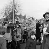 Princess Diana and Prince Charles visit Craigroyston in Edinburgh, March 1983. Photographers capture the moment when the Princess of Wales is handed some lucky white heather by nine-year-old Malcolm Smith.