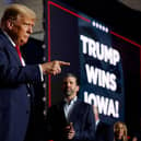 Republican presidential candidate, former US President Donald Trump, acknowledges supporters during his caucus night event at the Iowa Events Center in Des Moines, Iowa.