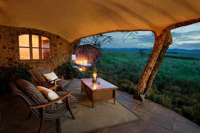 At Lewa House safari lodge, a collection of thatched cottage guest accommodation gazes out to Mount Kenya.